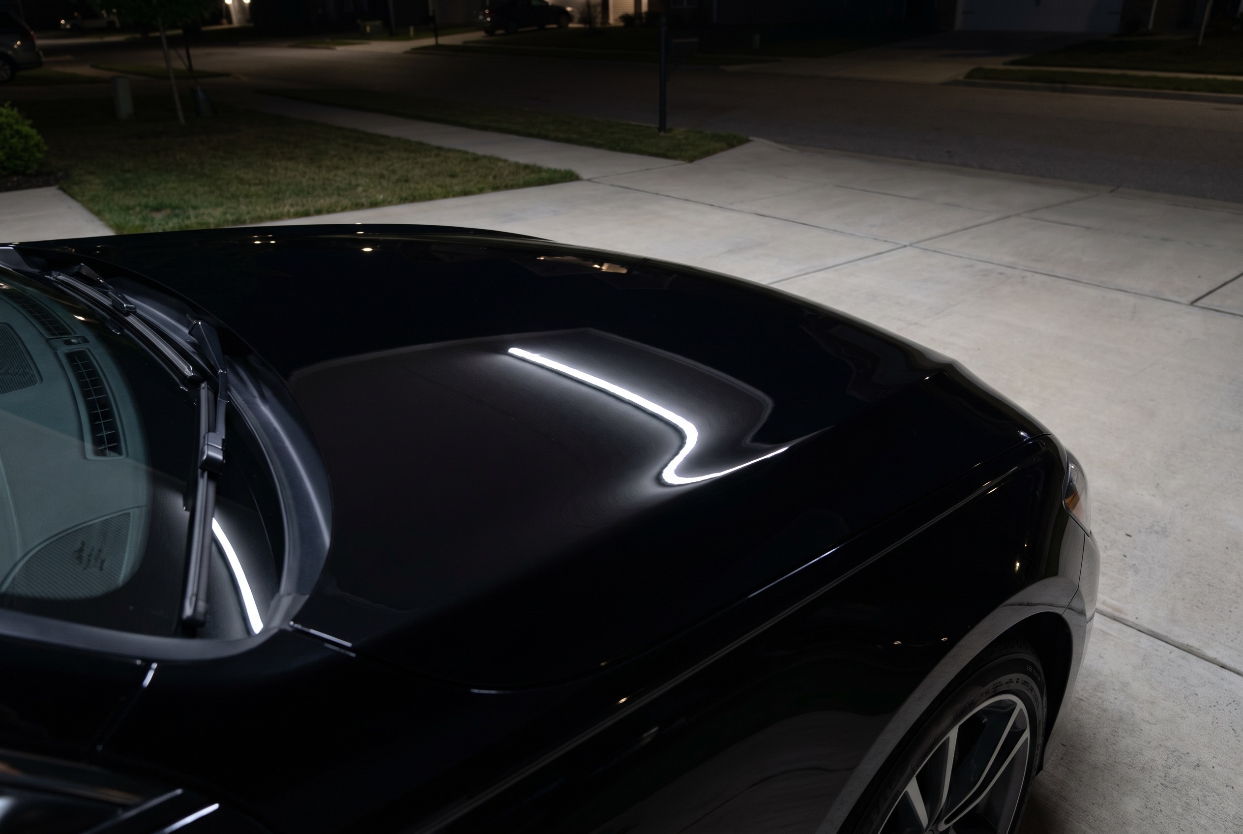The same hood after multi-stage paint correction, gloss restored
